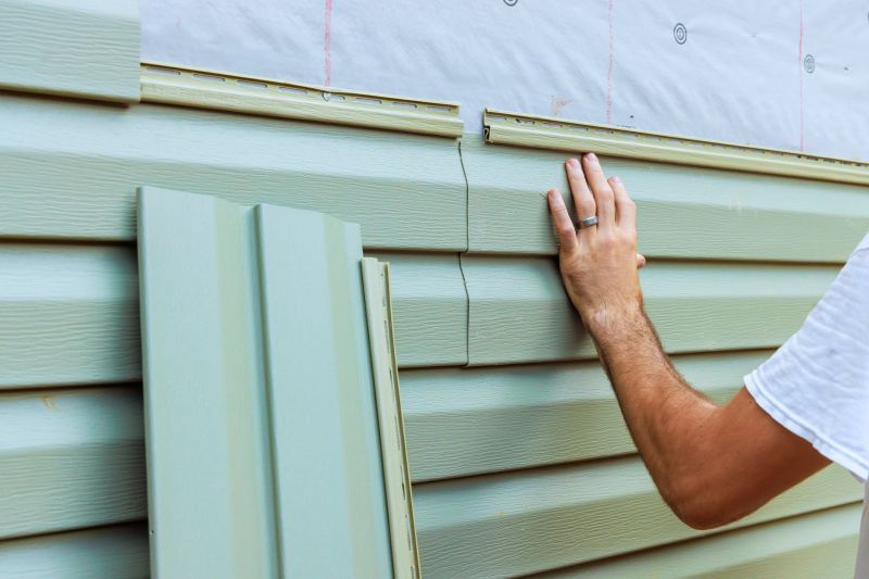 Vinyl siding professional inspecting installation